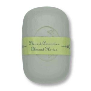 a curved french soap that is almond flower scented sitting with a white background