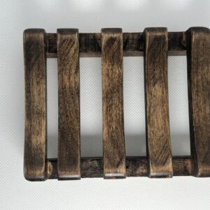 soap dish in a darker finish with a slight shimmer made from cherry wood slatted design