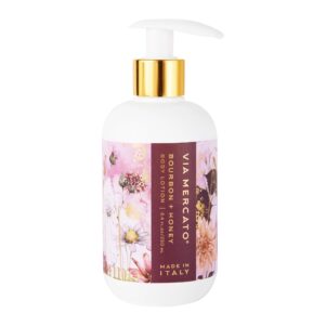 white lotion bottle with a burgundy and pink floral label. bourbon and honey scented lotion