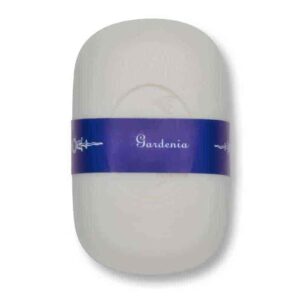 a curved french soap that is gardenia scented with a white background