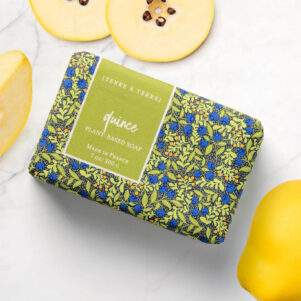 french bar soap wrapped in blue and light green paper. quince scented