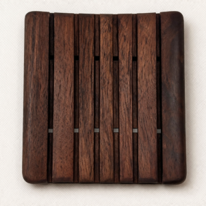 soap dish in a dark walnut stain with grooves and a slight curve measuring 3.75" x 3".